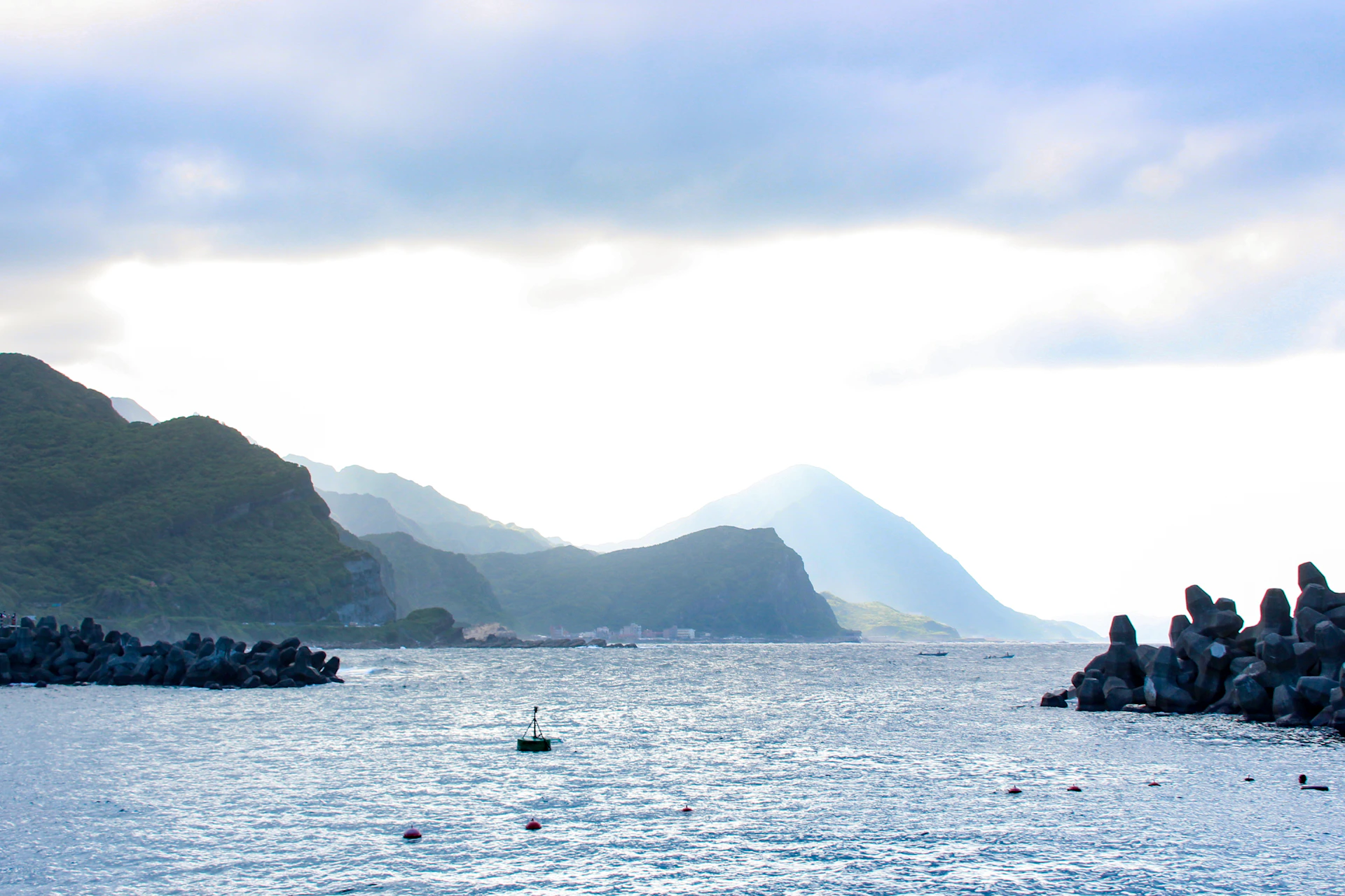 a body of water with mountains in the background
