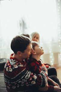 Warm photo of a father and son discussing property details in a cozy office.