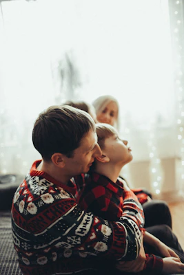 A warm family scene showing a father and son sharing a heartfelt conversation at home.