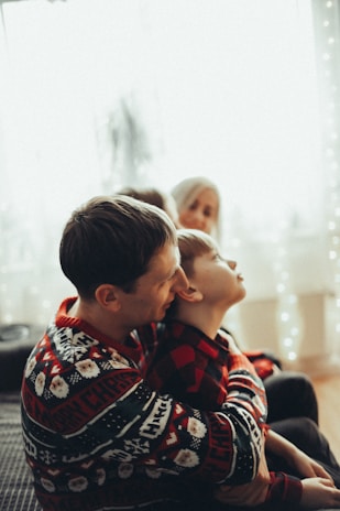 Warm family moment showing a parent reading to a young child in a cozy home setting.