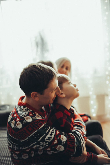 A warm family moment showing a father and son sharing a heartfelt conversation in a cozy living room.