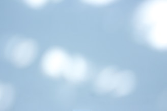 Soft light blue and purple abstract background with subtle business icons.