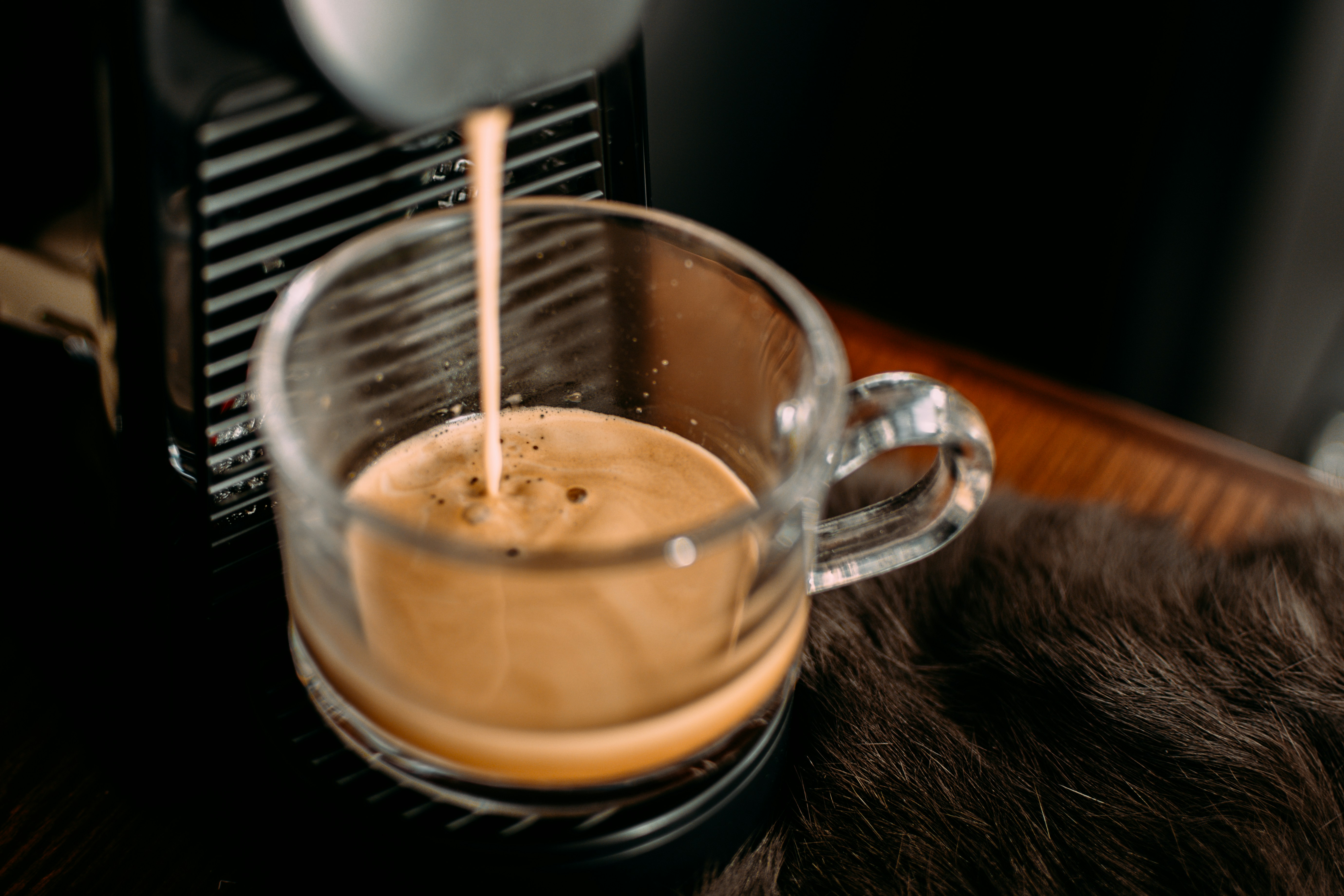 a cup of coffee being poured into it