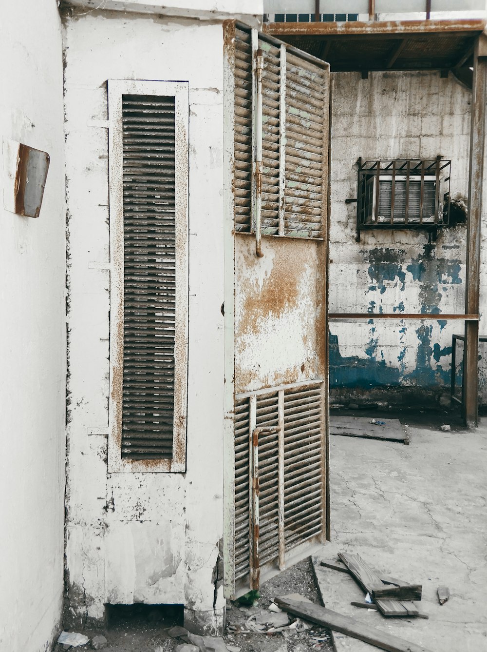 an old run down building with shutters open