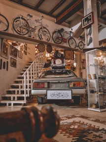 a car parked in a garage next to a bunch of bikes