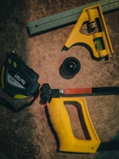 a pair of pliers, a tape measure, and a pair of pliers