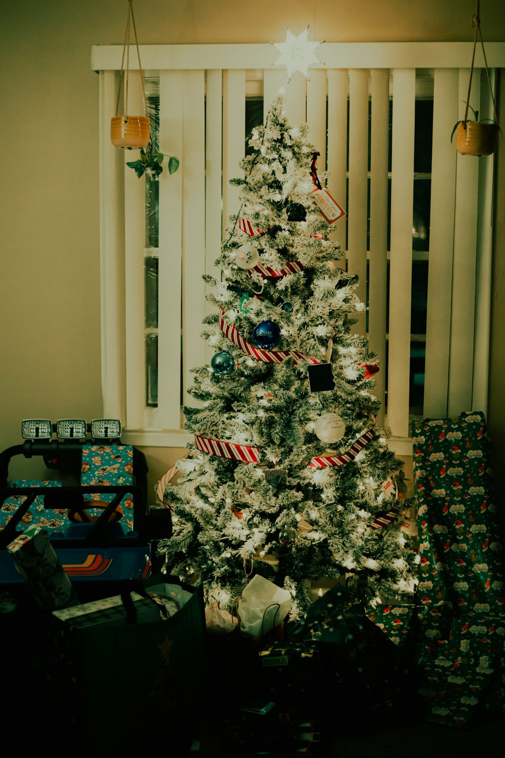 a white christmas tree with presents under it