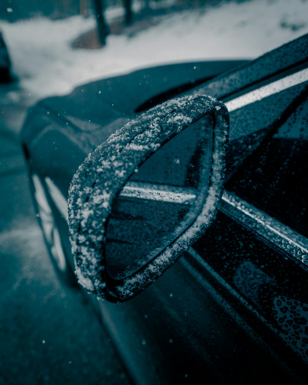 a close up of a car door with snow on it