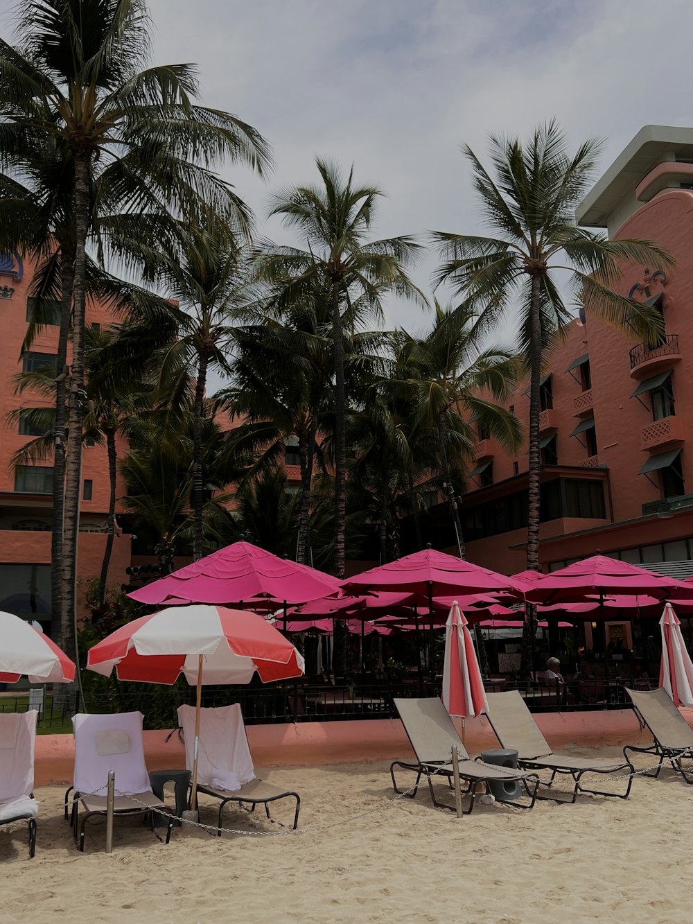 a bunch of chairs and umbrellas on a beach