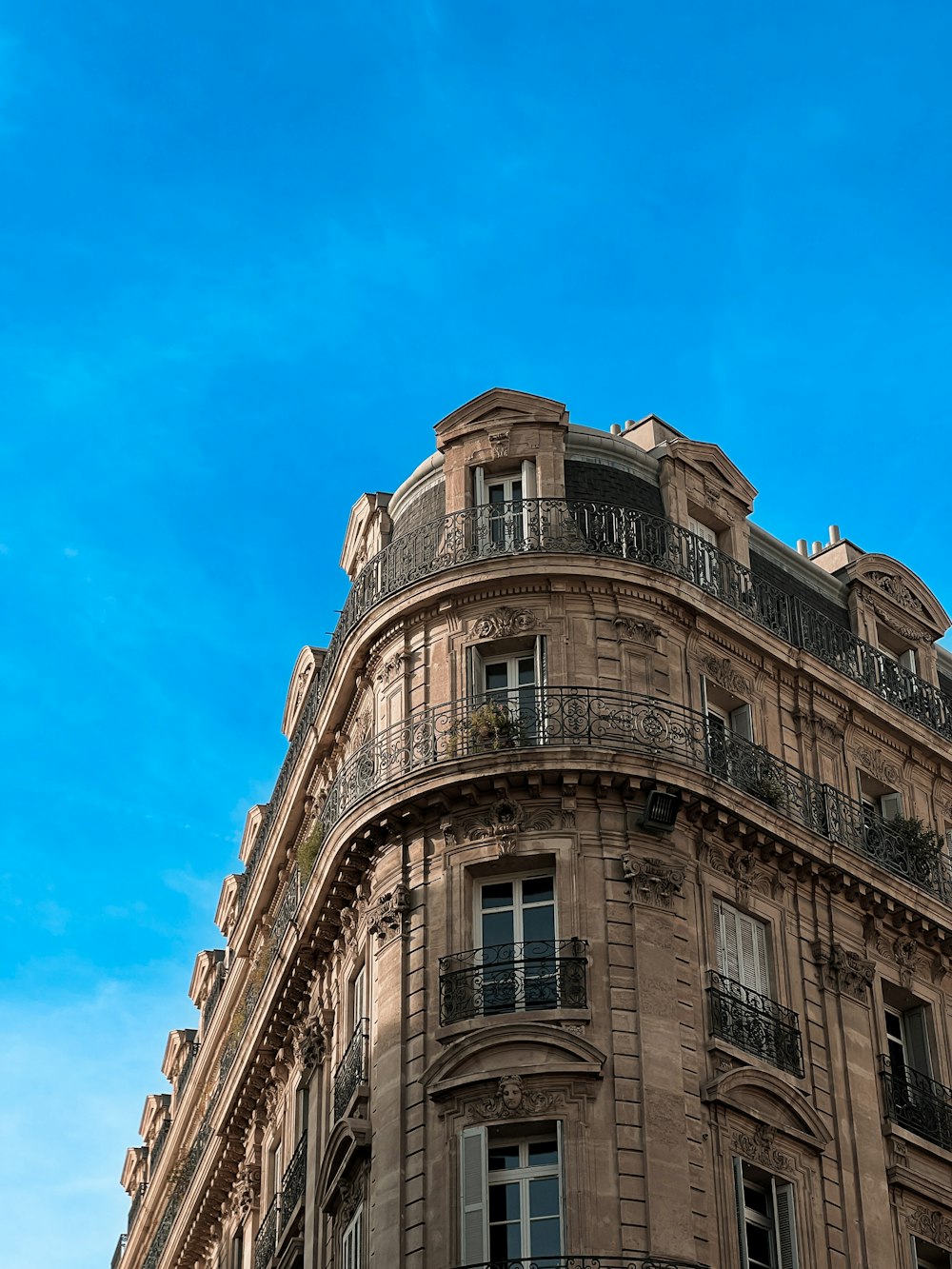 a tall building with balconies and balconies on the top of it