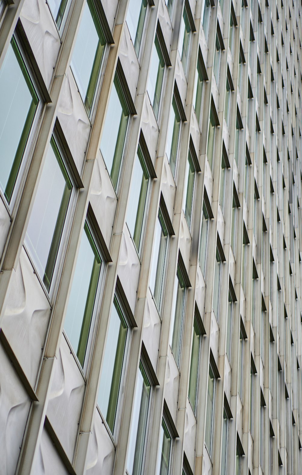 a tall building with lots of windows next to a clock