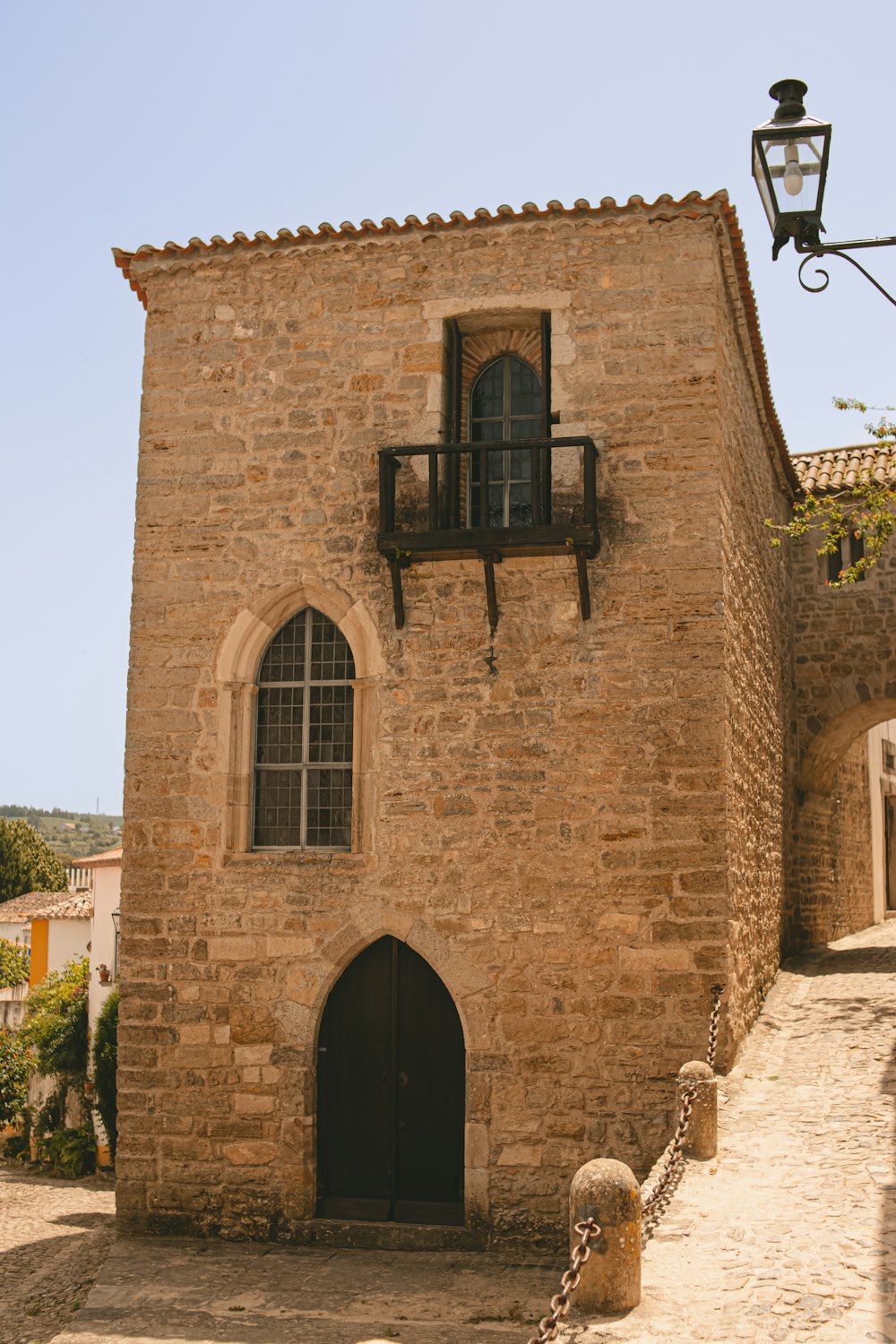 a stone building with a black door and window