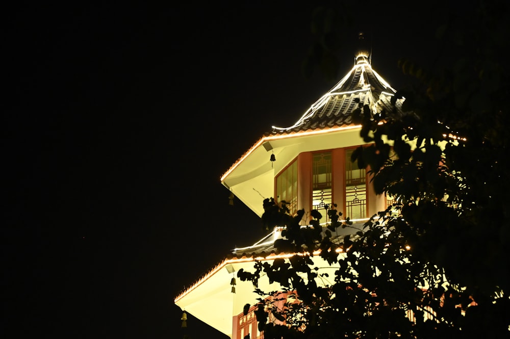 a clock tower lit up at night time