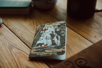 A cozy scene with a 7x9 inch notebook featuring a hand-drawn nature design on the cover, surrounded by autumn leaves.