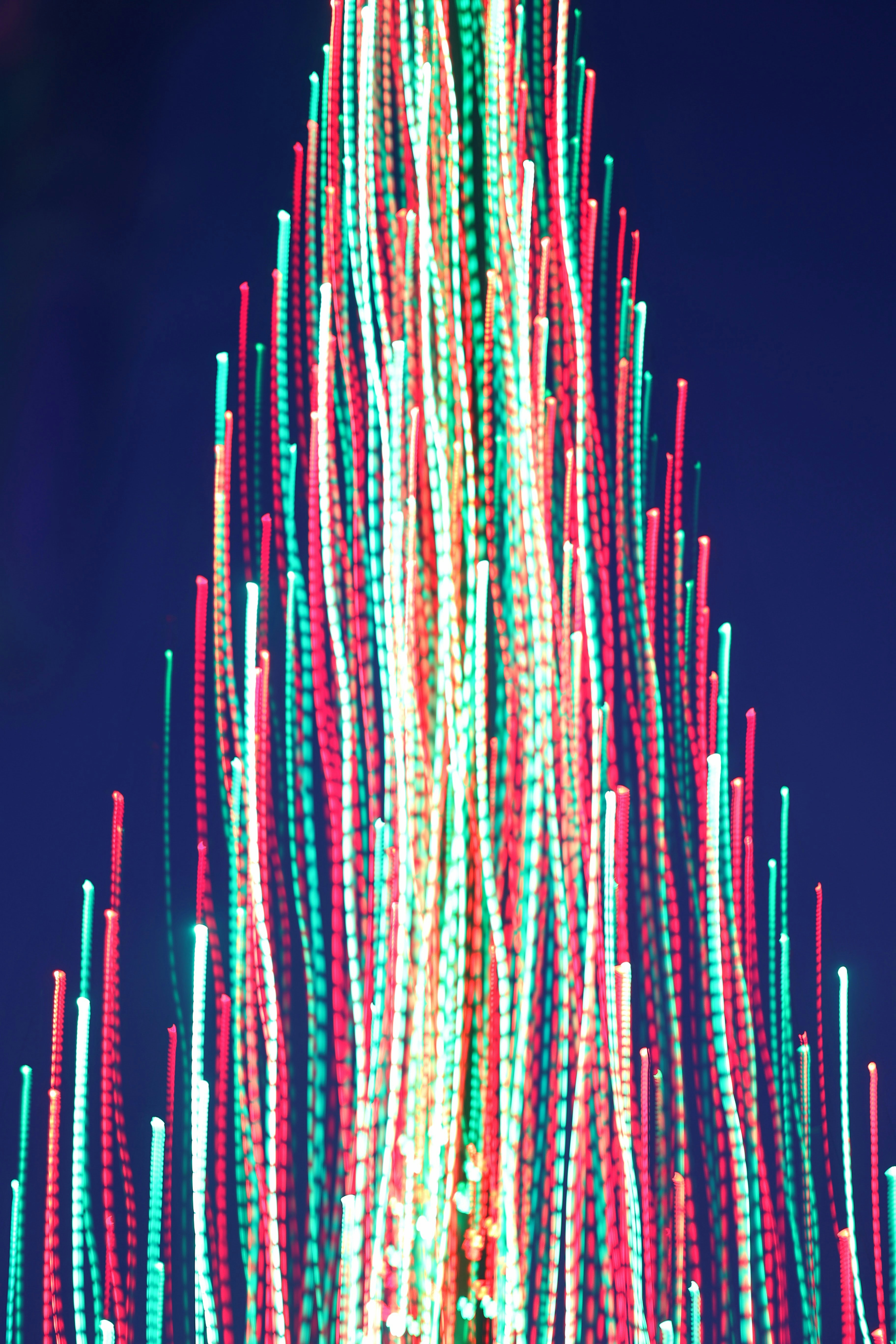 a large christmas tree with lights on top of it