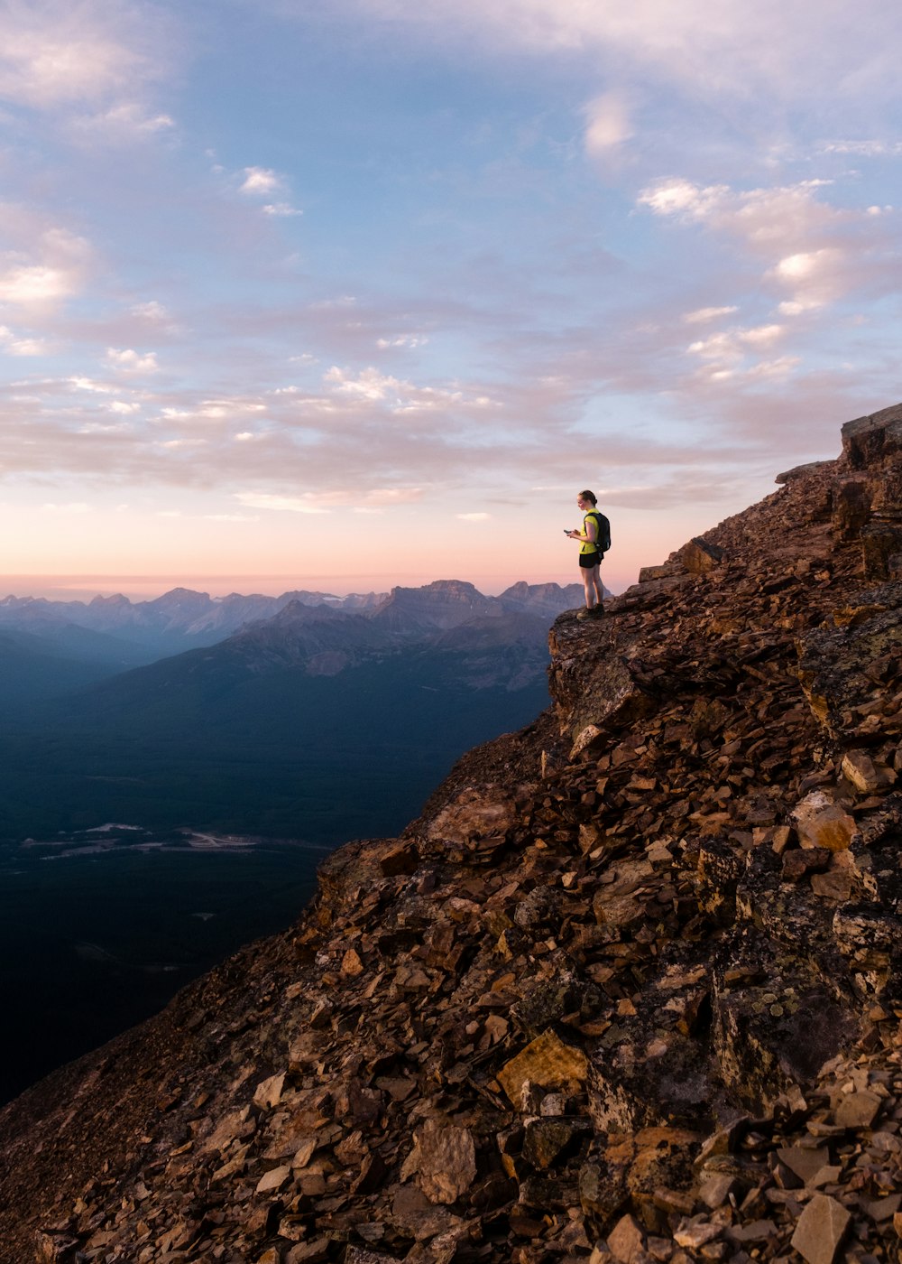 a man standing on top of a rocky mountain