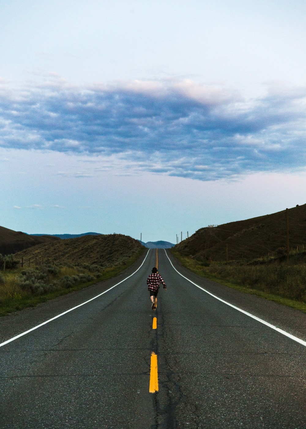 a person riding a bike down a road