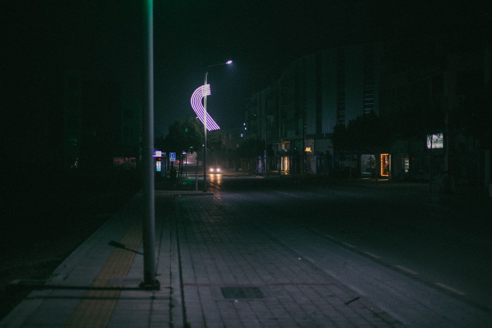 a dark street at night with a street light