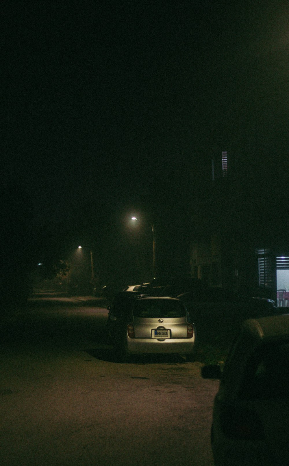 a car parked on the side of the road at night