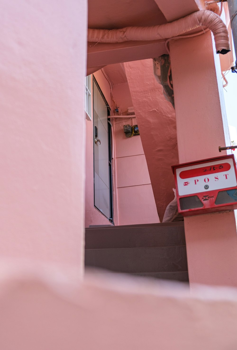 a pink building with a red and white sign