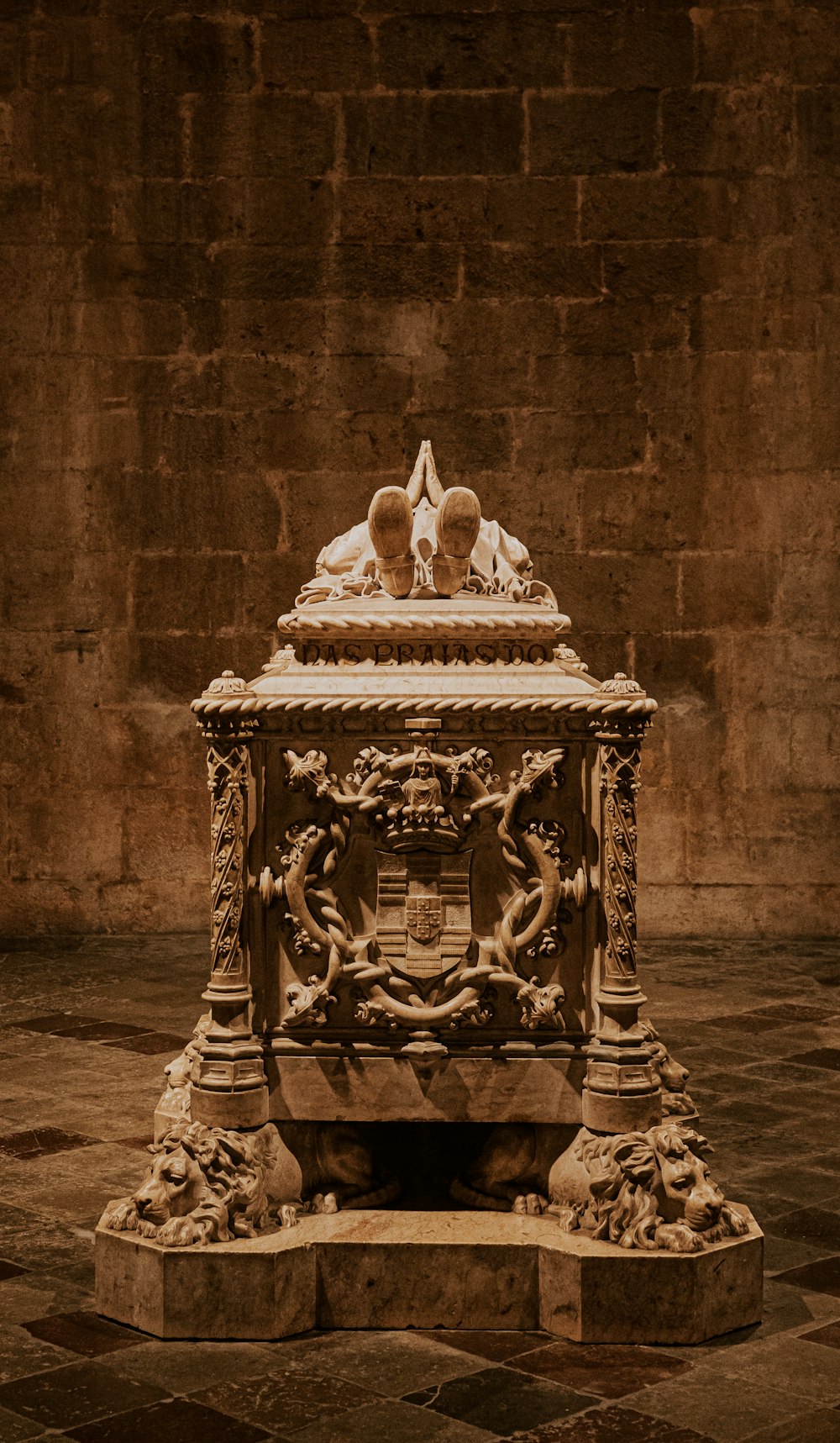 a statue of two people sitting on top of a bench