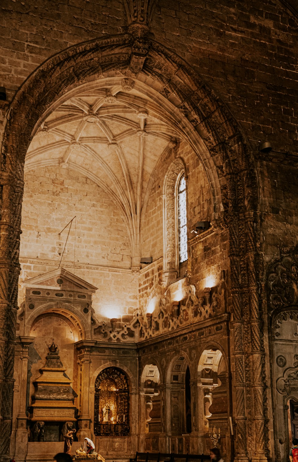 a church with a large stone wall and vaulted ceiling