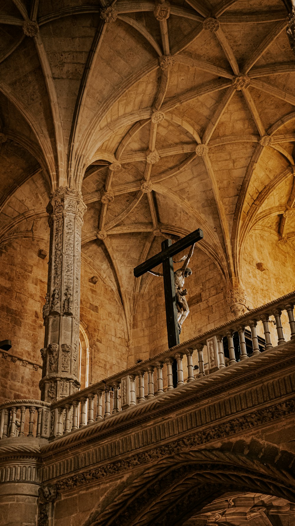 a statue of a person on a cross on a balcony