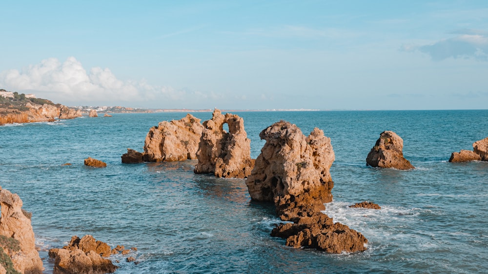 a body of water with rocks in the middle of it