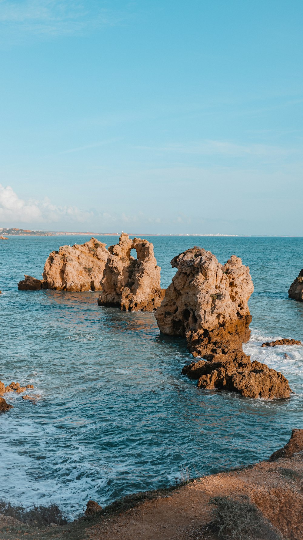 a body of water with rocks in the middle of it