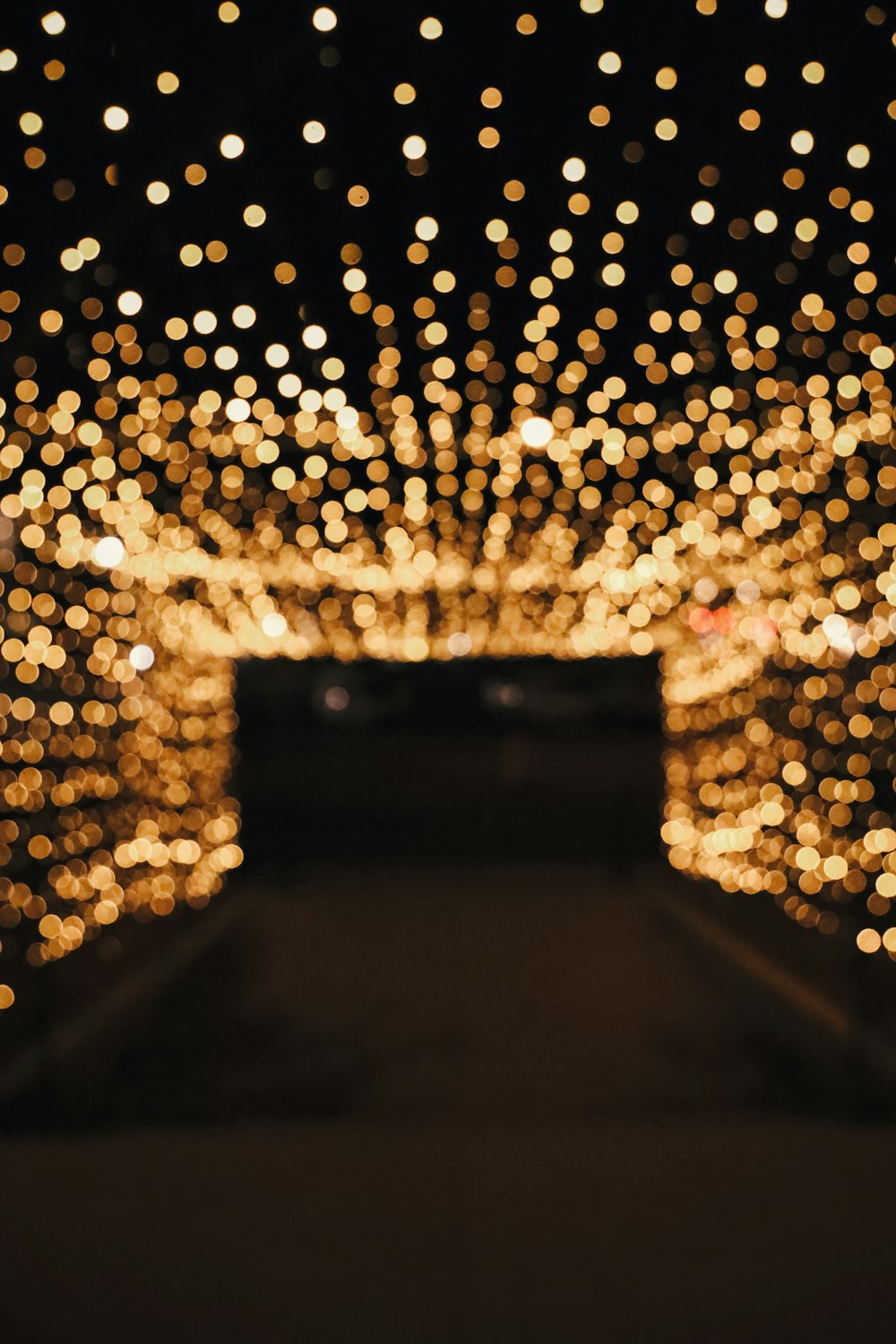 a tunnel of lights in the middle of a walkway