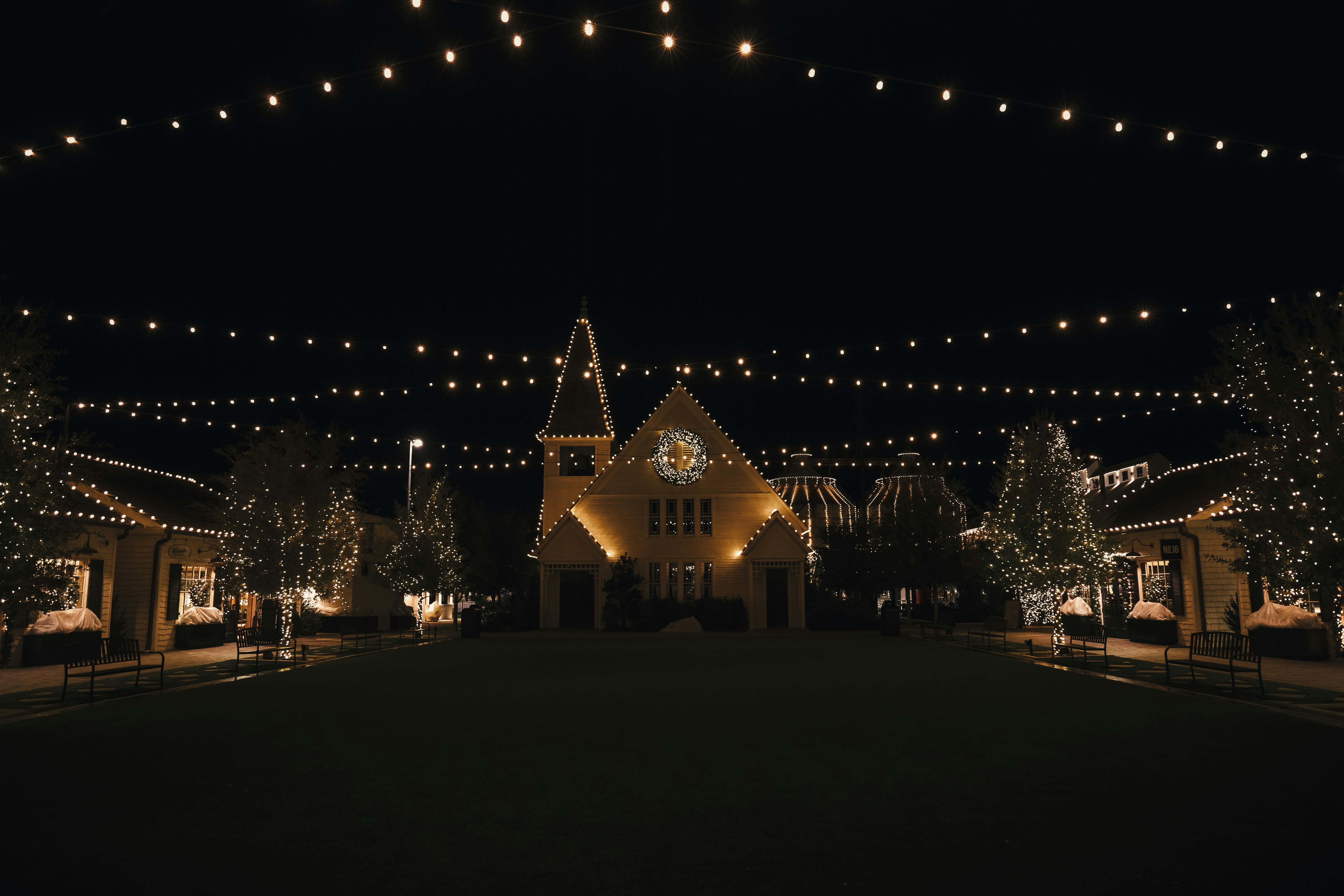 a lit up building with a clock on the front of it