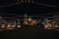 a lit up building with a clock on the front of it