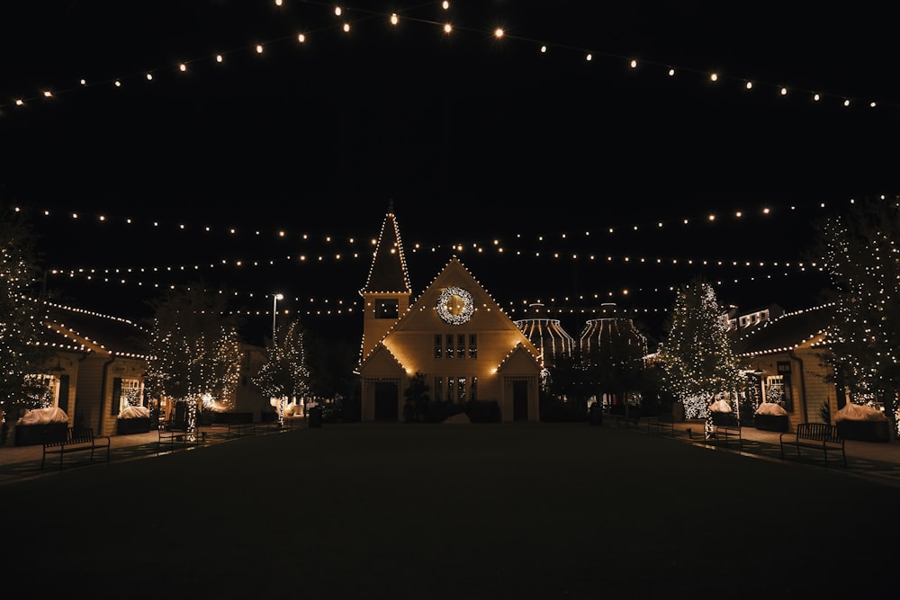 a lit up building with a clock on the front of it