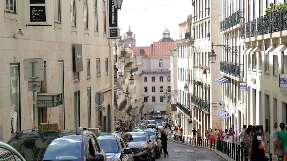 a city street filled with lots of traffic next to tall buildings