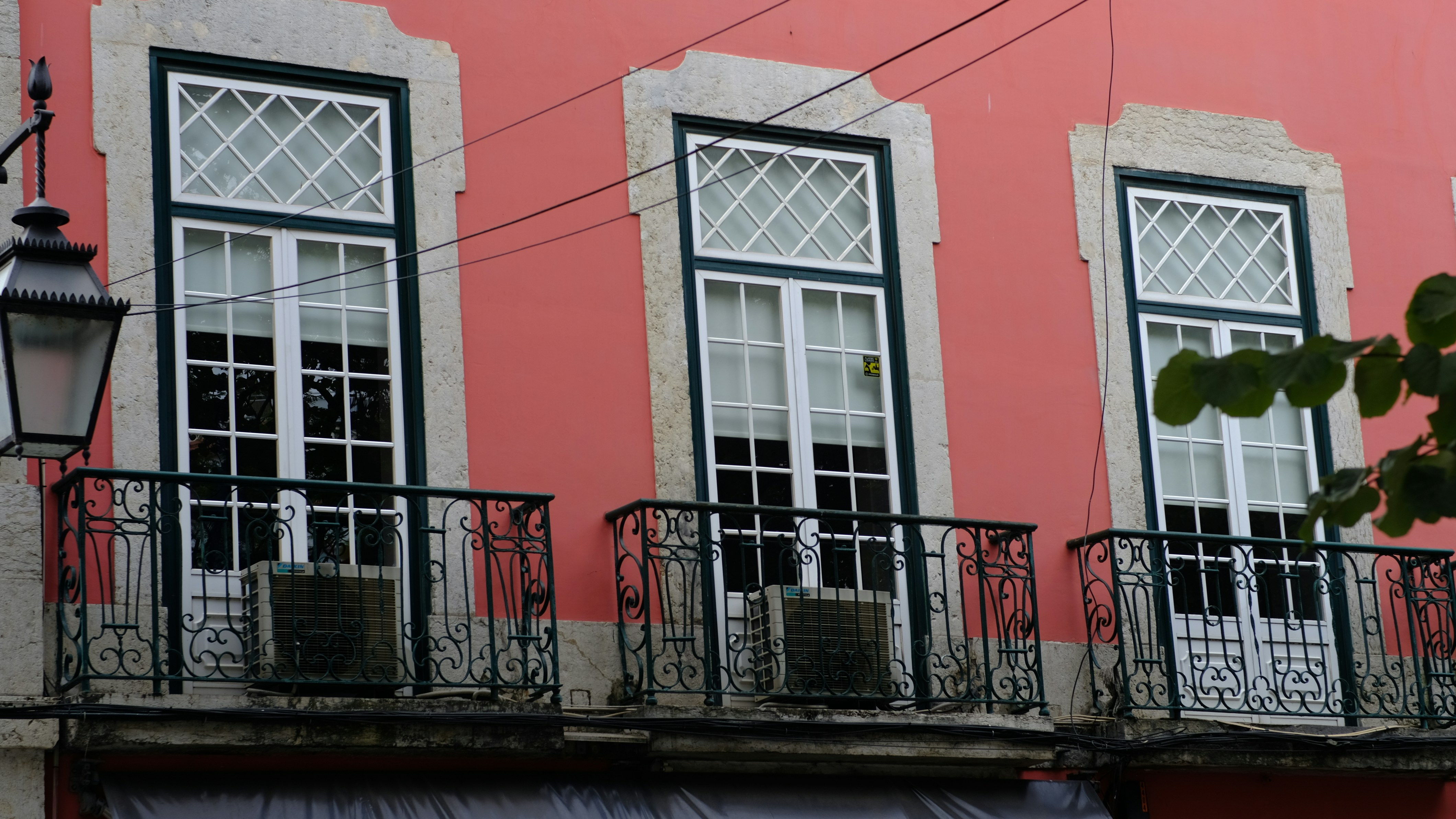 Un edificio rojo con tres ventanas y un balcón