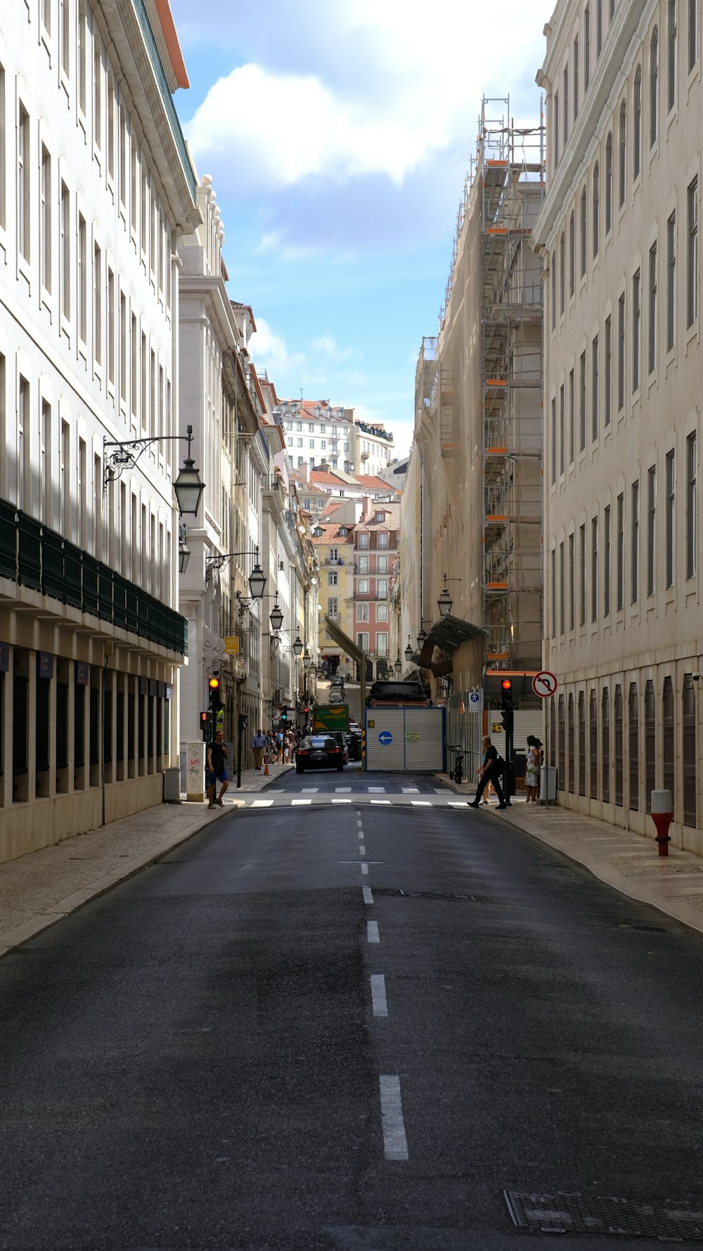a city street lined with tall white buildings