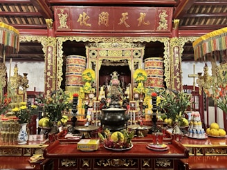A serene altar setup with traditional incense and paper offerings.
