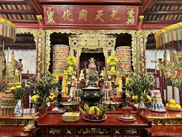 An antique altar adorned with ritual symbols, dried herbs, and softly glowing lanterns.