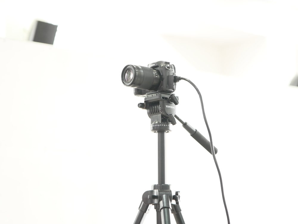 a tripod with a camera attached to it