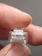 Close-up of a hand holding a thick Detoflex cable with a clear brand logo.