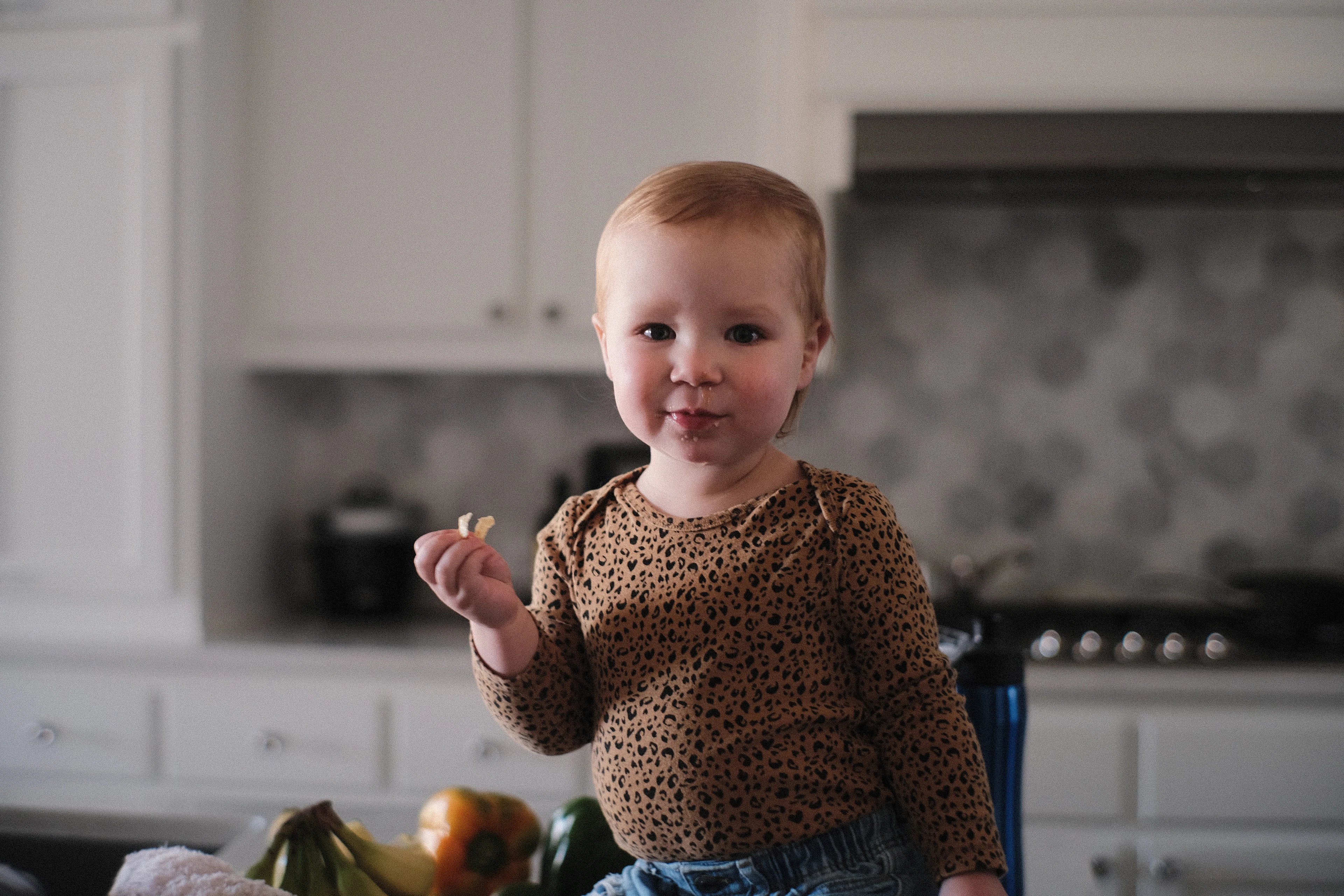 Little girl standing in a family kitchen