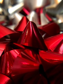 Variety of vibrant hair bows spread out on a soft fabric background.