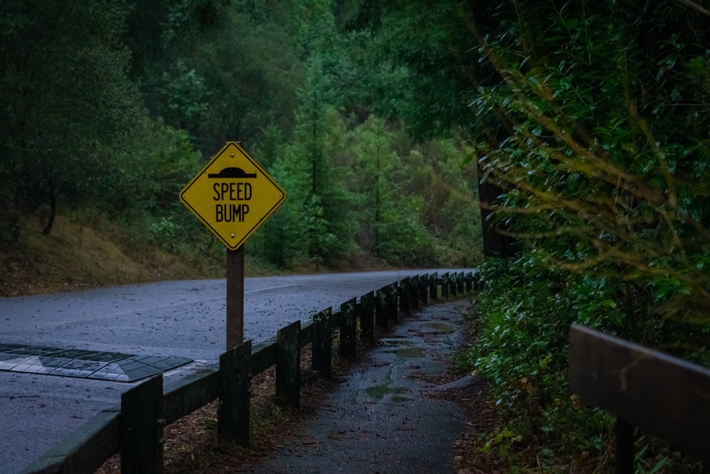 a yellow sign sitting on the side of a road