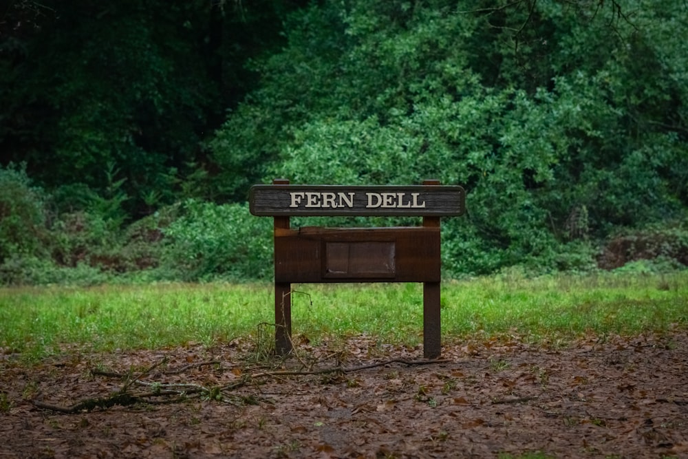 a wooden bench sitting in the middle of a forest