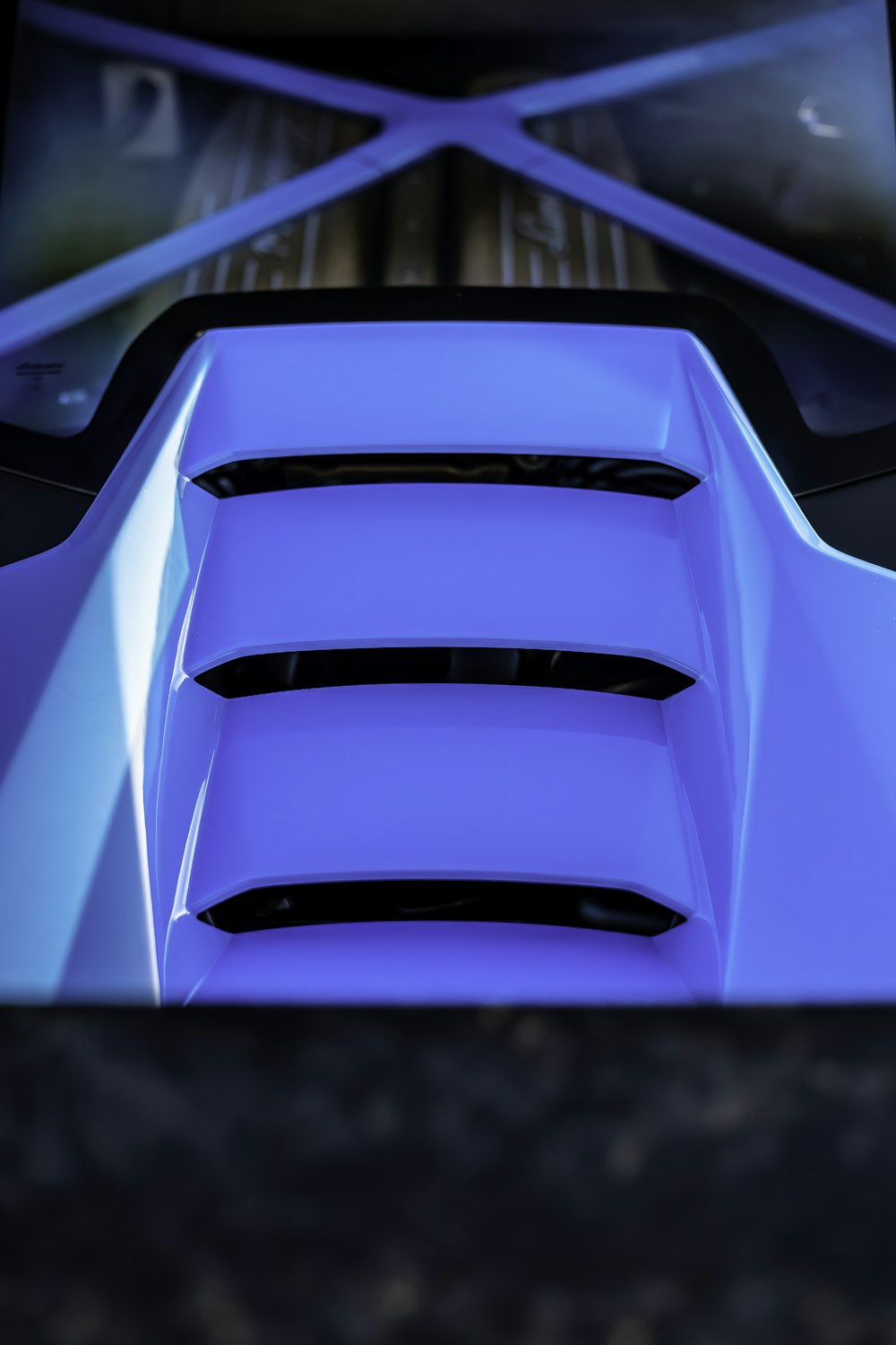 a close up of a blue car's hood