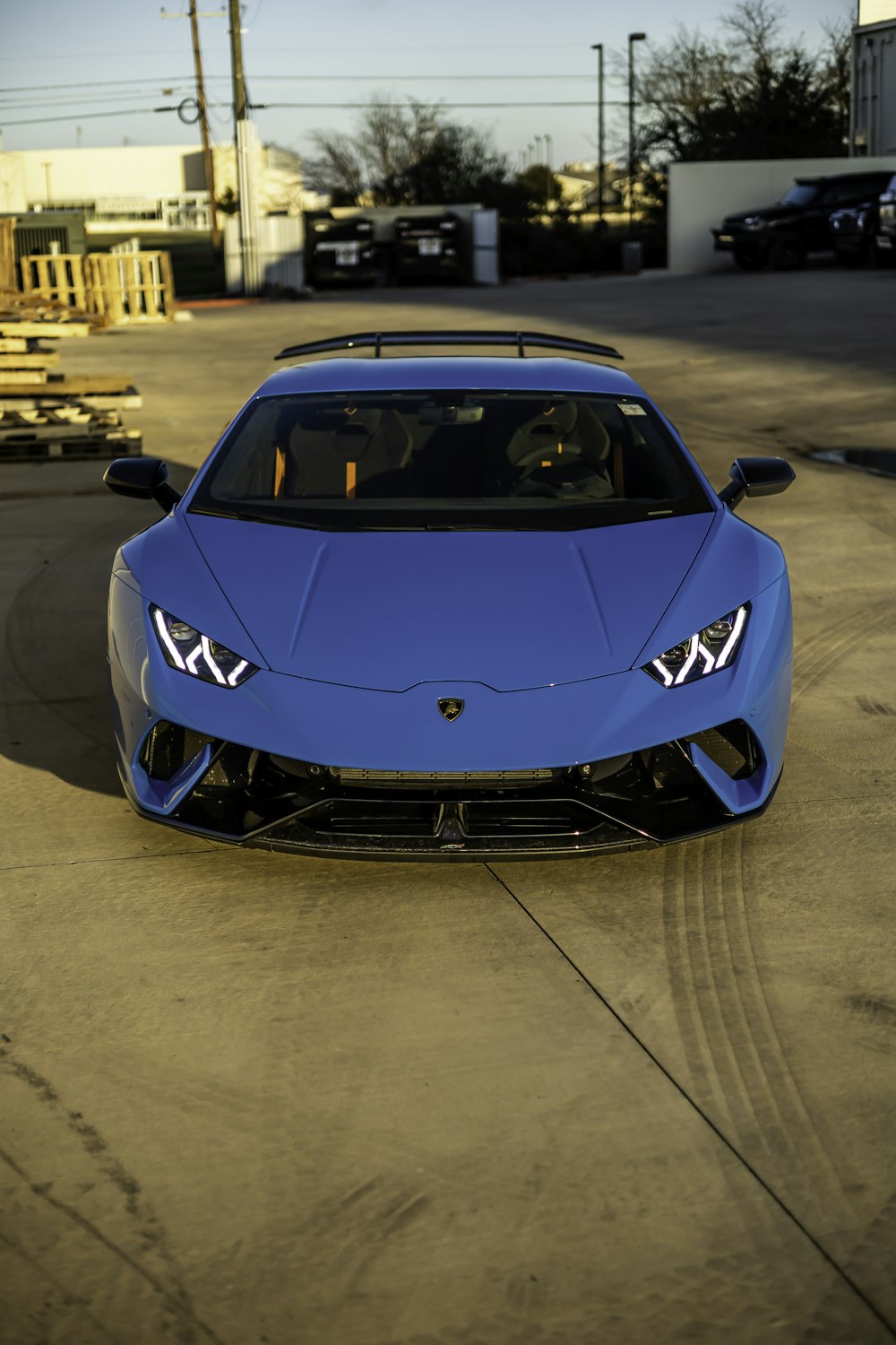 a blue sports car parked in a parking lot