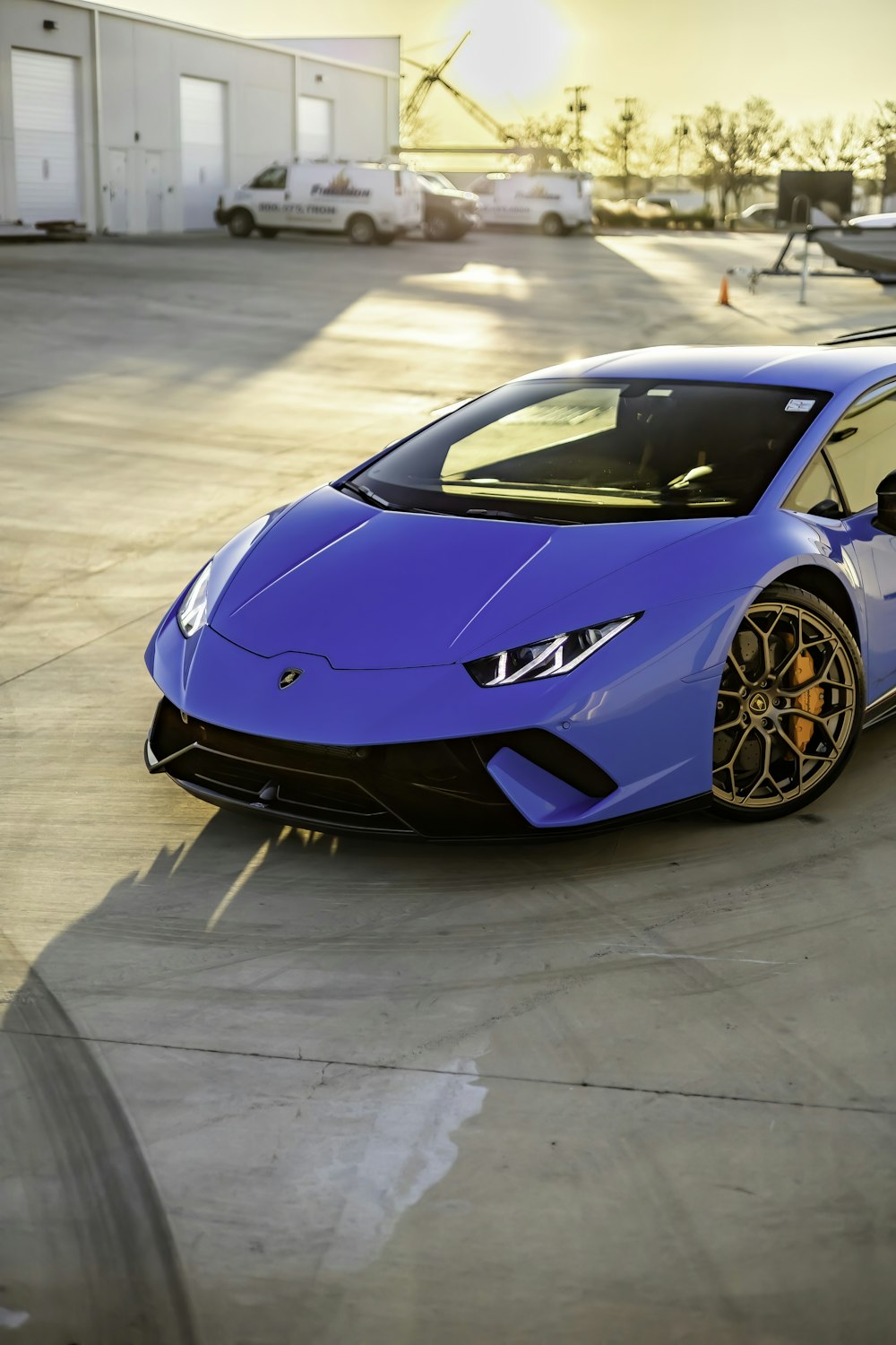 a blue sports car parked in a parking lot