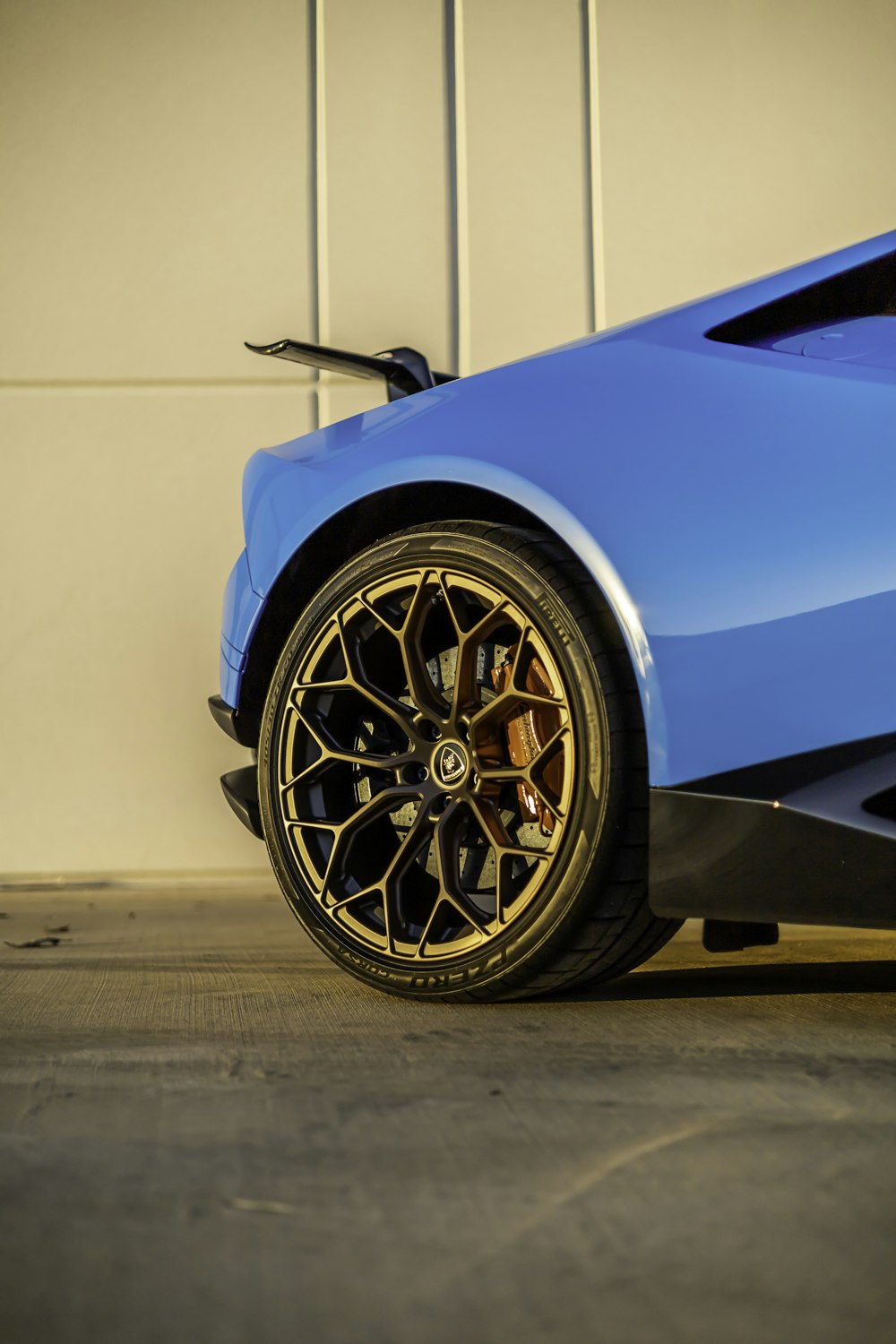 a blue sports car parked in a garage