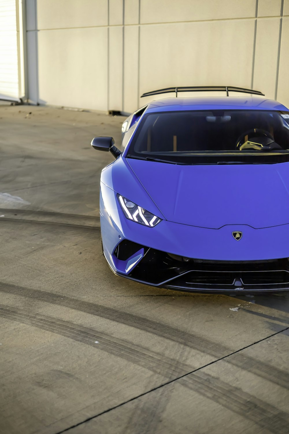 a blue sports car parked in a parking lot