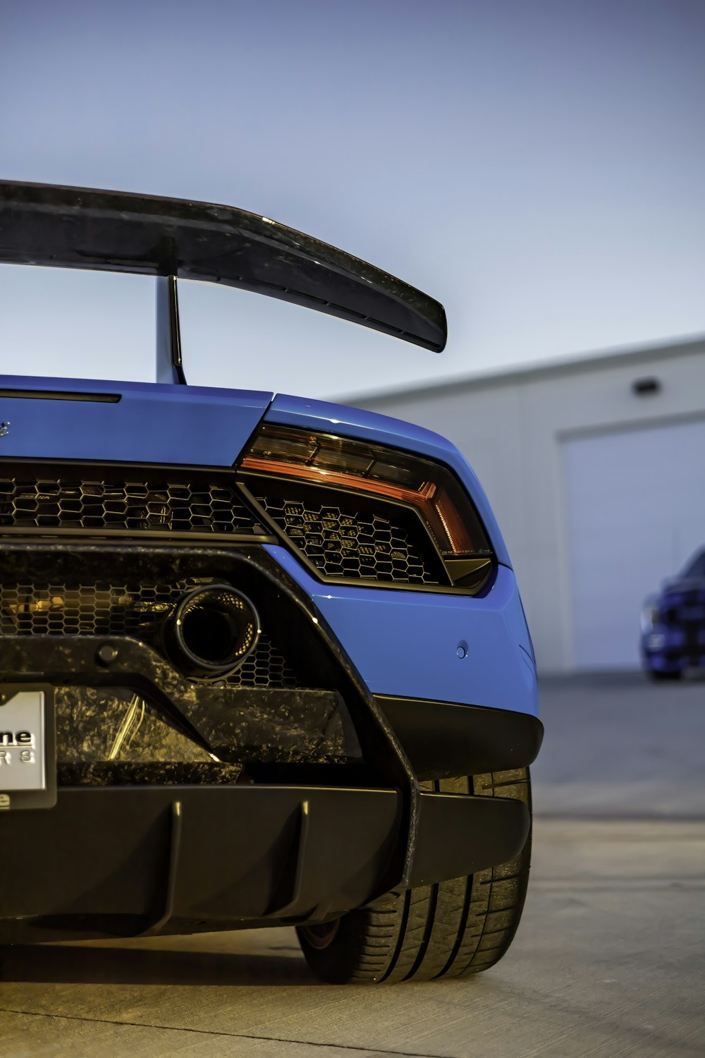 a blue sports car parked in a parking lot